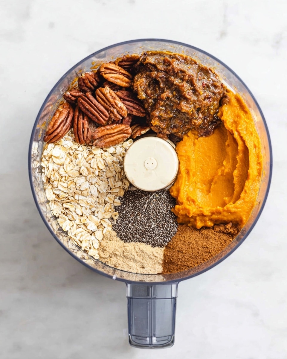 A clear food processor bowl sits on a white marbled surface, filled with six visible layers arranged in sections around the central blade. Starting from the top, there are whole pecans with a dark brown, wrinkled texture, and next to them is a sticky brown paste with some darker spots. Below this paste is a bright orange, smooth layer of puree. To the left is a layer of dry rolled oats with a light beige color, beside the oats is a pile of fine brown powder, and above the powder is a small clump of black chia seeds. The layers are all dry or dense textures, and they sit separated in the bowl ready to be mixed. Photo taken with an iphone --ar 4:5 --v 7