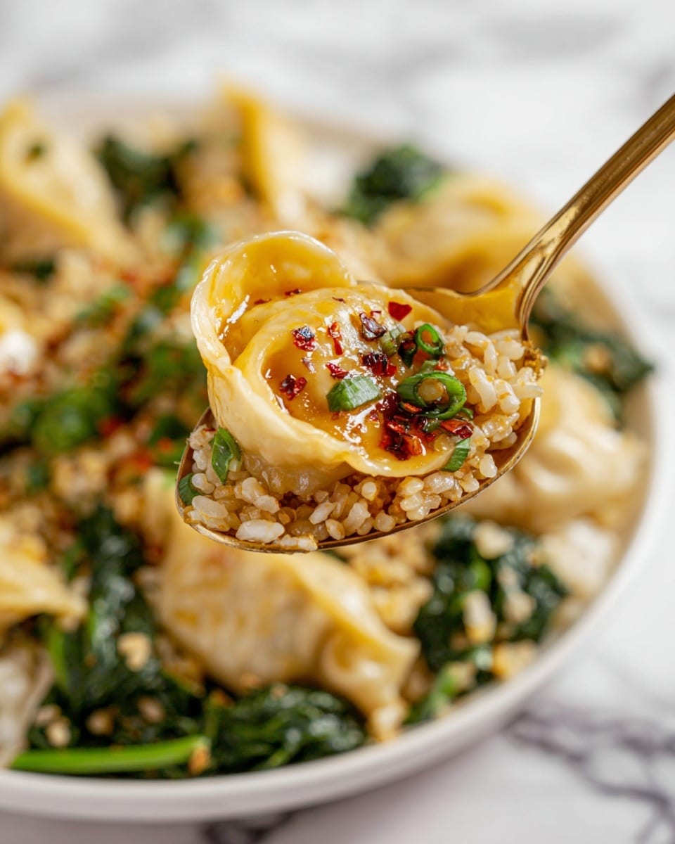 A close-up image of a gold spoon holding one dumpling, shiny and light yellow with a soft texture, mixed with grains of light brown rice and a few green leafy vegetables, slightly glossy from sauce with red chili flakes on top. Below the spoon, there is a white plate filled with more dumplings, rice, and green leafy vegetables, all on a white marbled surface. Photo taken with an iphone --ar 4:5 --v 7