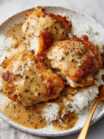 Southern Smothered Chicken Thighs with Gravy and Rice Recipe