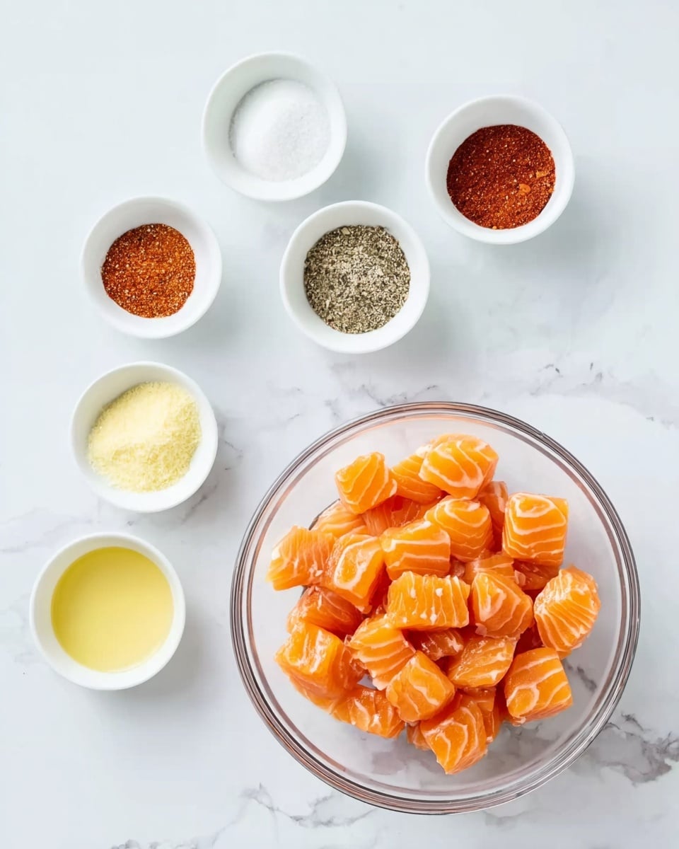 The image shows a clear glass bowl filled with many small, orange salmon pieces that have white lines on them, placed near the center of a white marbled surface. Surrounding the bowl, there are six small white bowls arranged in two rows above and to the left of the main bowl. The bowls contain different powders and liquids: top row from left to right has white powder, reddish-brown powder, black and white pepper mix, and red powder; the bottom left row has a pale yellow powder and a bowl of light yellow liquid. The overall scene is bright and clean. Photo taken with an iphone --ar 4:5 --v 7