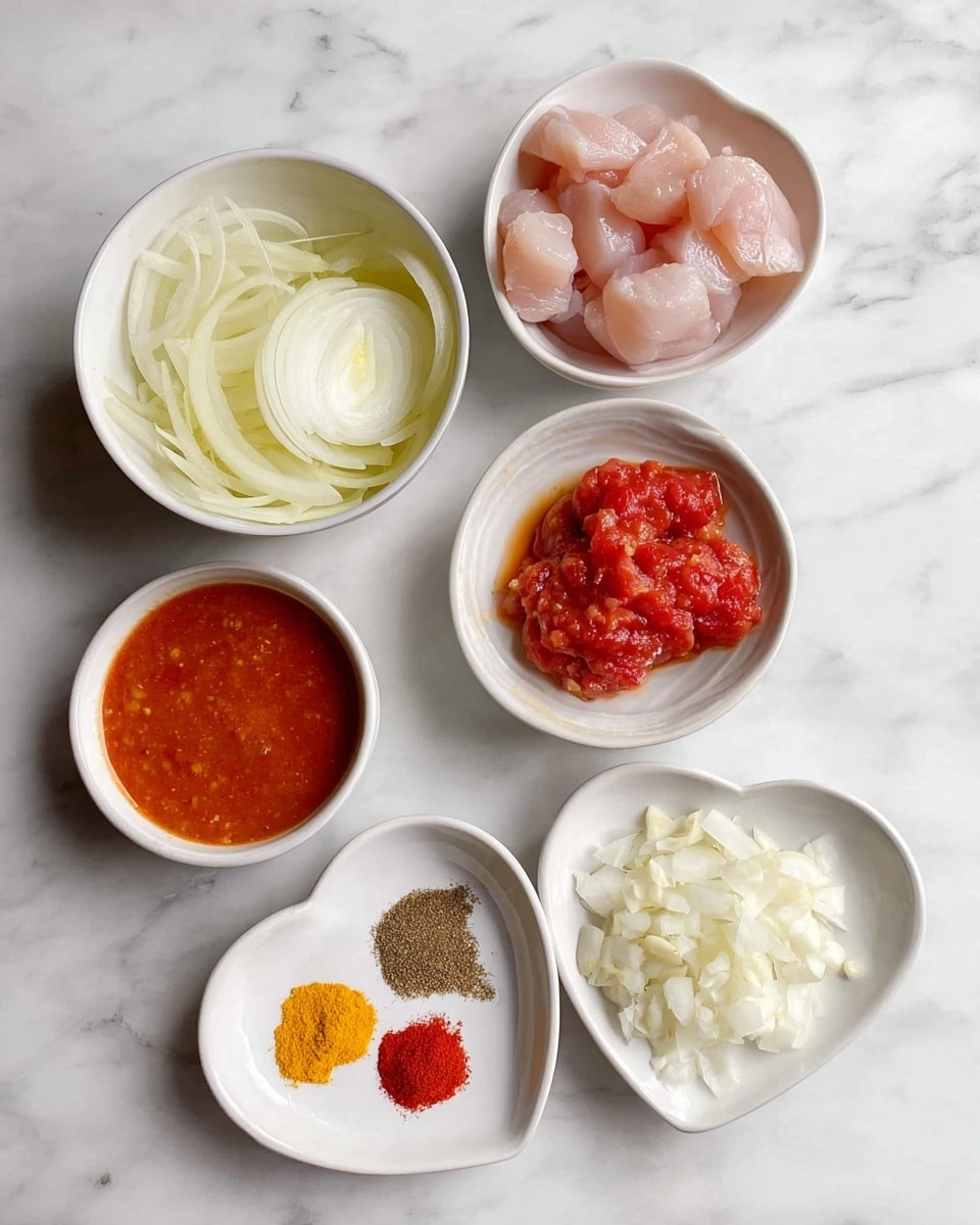 There are six small white bowls on a white marbled surface. One bowl contains thinly sliced onions in light yellow and white. Another bowl holds a creamy white liquid, smooth in texture. A third bowl has a chunky red tomato sauce with visible pieces of tomato. The fourth bowl contains raw pink chicken pieces. The fifth bowl has several bright spices: orange turmeric, deep yellow, dark brown, red paprika, and a light brown powder, all arranged in small piles. The sixth bowl is heart-shaped and filled with finely chopped white garlic. photo taken with an iphone --ar 4:5 --v 7