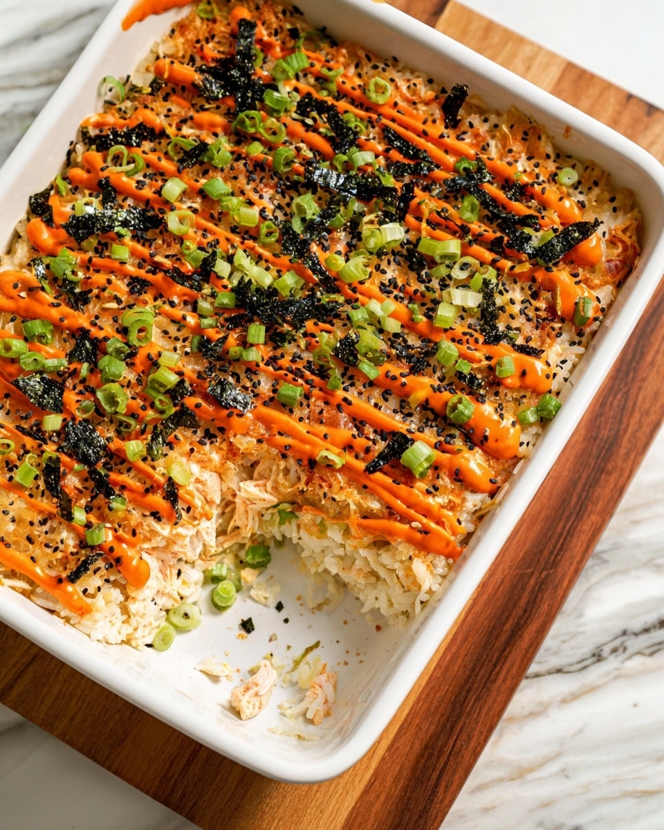 A white rectangular dish filled with a layered baked rice dish. The bottom layer is white rice, topped with a thick layer of creamy orange seafood mix with visible bits of crab and other seafood. The top layer is drizzled with bright orange sauce in diagonal lines, sprinkled with black sesame seeds, small pieces of black seaweed, and chopped green onions scattered evenly across the surface. A square section is missing, showing the layers clearly. The dish is placed on a wooden board with a white marbled surface underneath. Photo taken with an iphone --ar 4:5 --v 7