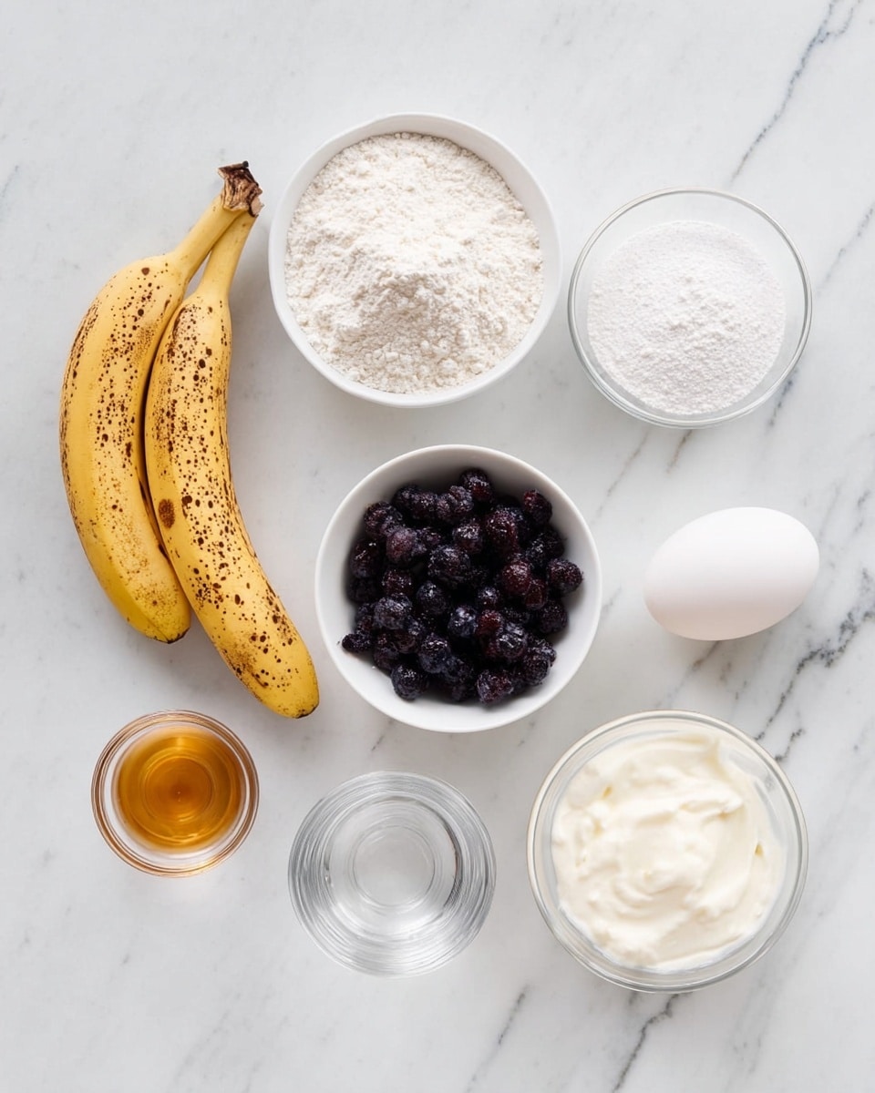 A white marbled surface holds eight items arranged neatly: a ripe, spotted yellow banana with brown freckles lies on the bottom left; above it, a white bowl filled with white flour shows a fine, powdery texture; to the top right of the flour, a small clear glass bowl holds white baking powder, looking smooth and fine; next to it, a white bowl is full of dark purple-blue frozen blueberries with a slight frost layer; below the blueberries, a single white egg rests smoothly; to the right and slightly below the flour, a clear glass bowl is filled with white creamy yogurt with a soft texture; next to it on the right, a small clear glass bowl contains a golden brown liquid, likely vanilla extract; finally, below the vanilla, a clear round glass holds water or a clear liquid. The setup is clean and bright, with each item distinctly separated and easy to identify. photo taken with an iphone --ar 4:5 --v 7