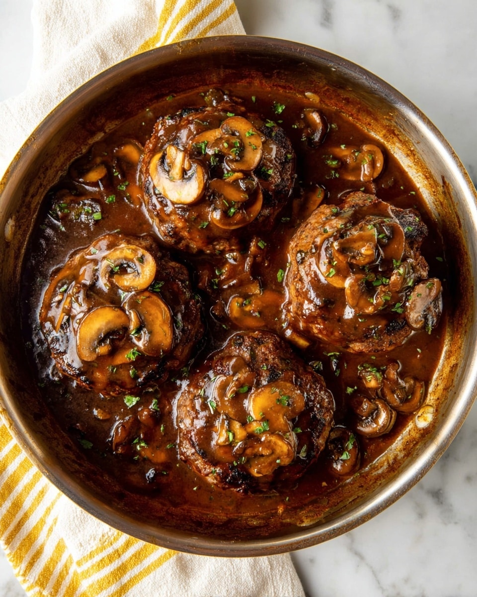 There is a round pan filled with four thick, brown patties covered in dark brown mushroom sauce. Each patty has sliced mushrooms on top, and the sauce around them is glossy and rich with bits of mushrooms and herbs scattered lightly. The pan sits on a white marbled surface with a white cloth that has yellow stripes underneath it. Photo taken with an iphone --ar 4:5 --v 7