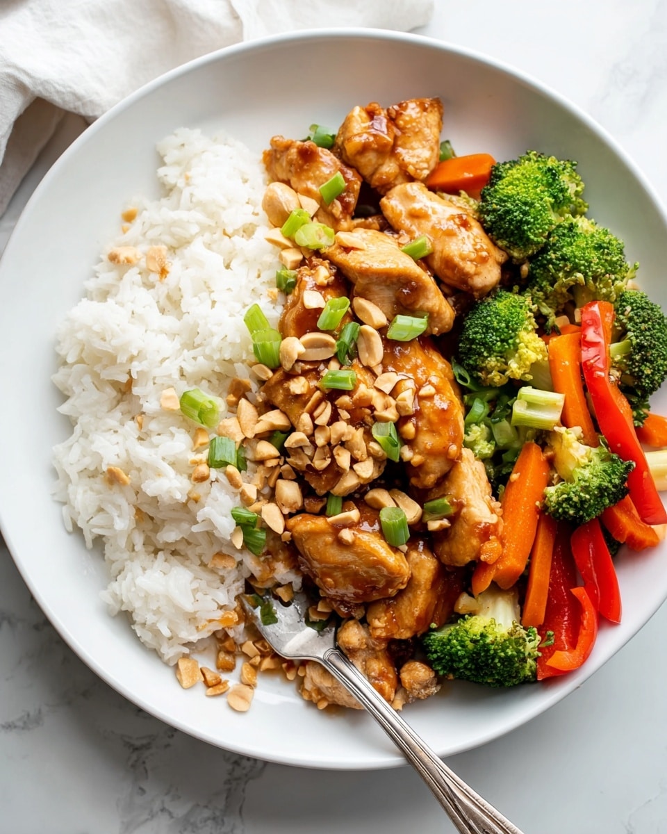 A white round plate on a white marbled surface holds three main layers: on the left side, there is a large section of fluffy white rice with a silver fork resting partly on it; on the right side, there are several pieces of golden-brown glazed chicken topped with chopped peanuts and chopped green onions; next to the chicken is a colorful mix of roasted vegetables including bright green broccoli florets, thin orange carrot sticks, and red bell pepper strips. The layers are arranged clearly with the white rice forming the base, the chicken in the center with sauce glistening, and the vibrant vegetables to the right, creating a balanced and appetizing look. Photo taken with an iphone --ar 4:5 --v 7