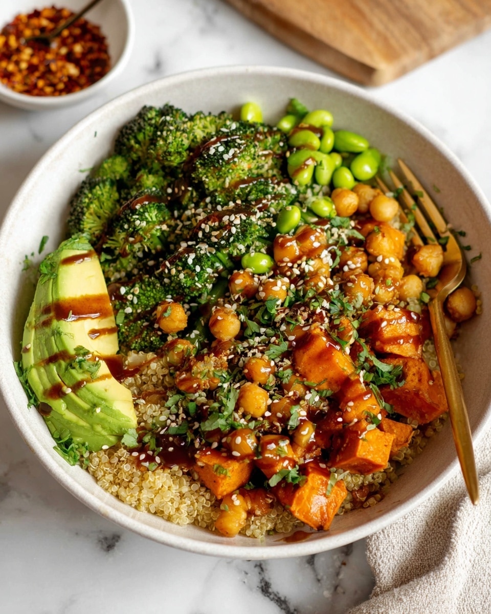 A white bowl filled with a base layer of light tan cooked quinoa, topped with bright green broccoli florets and edamame on the left side, and a half avocado with thin green slices placed in the middle-left. On the top layer, there are medium orange roasted sweet potato cubes mixed with beige roasted chickpeas sprinkled with white sesame seeds and red chili flakes. The dish is lightly drizzled with a dark brown sauce and garnished with fresh chopped green herbs. A gold fork rests inside the bowl on the right side. The bowl is set on a white marbled surface with a small white bowl of red chili flakes in the background. Photo taken with an iphone --ar 4:5 --v 7