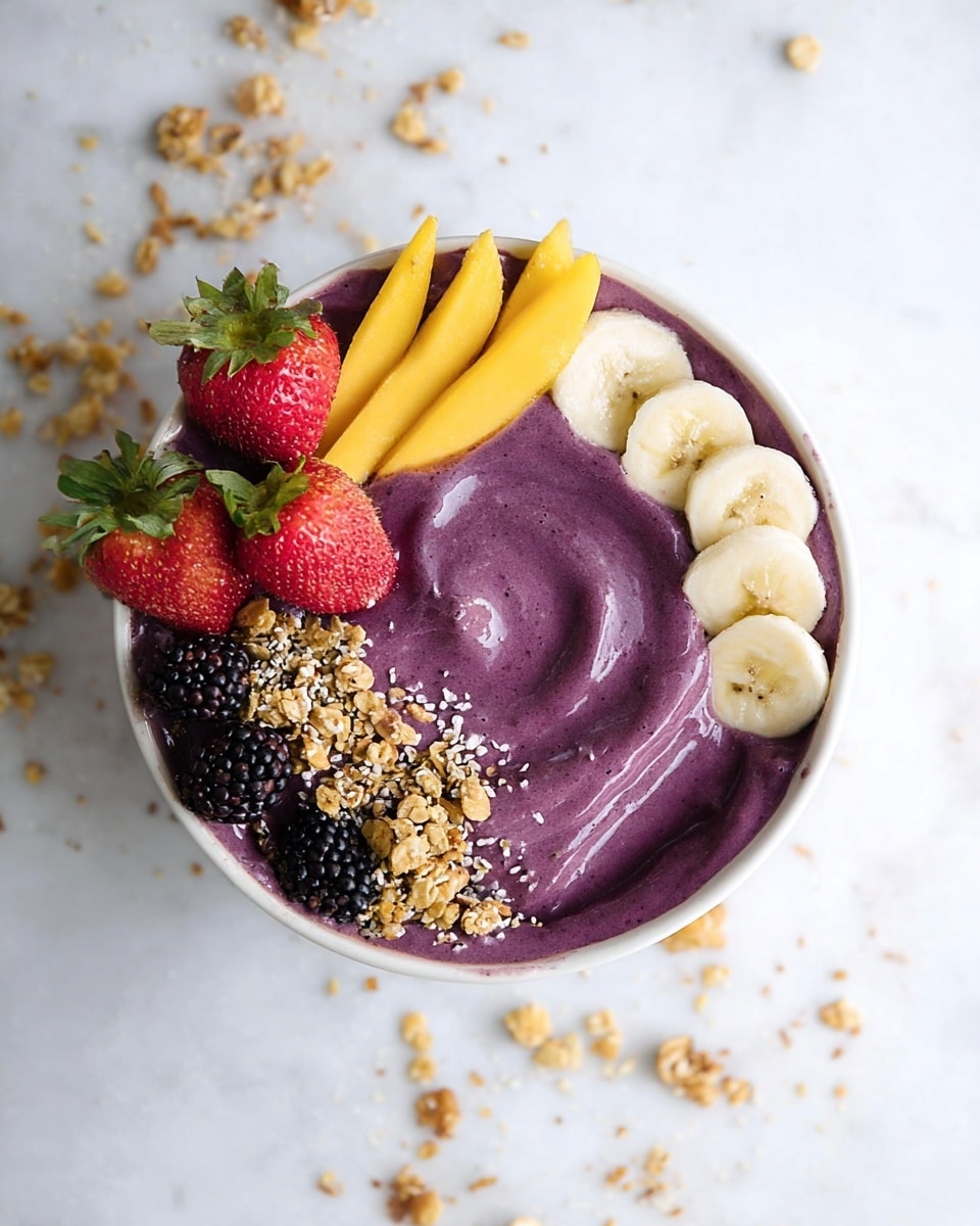 A white bowl filled with thick, smooth purple smoothie as the base layer, swirled gently in the center. On top, five thin yellow mango strips are placed side by side in a neat row in the upper right area. Next to the mango, five round slices of banana lay in a curved line on the right side. On the left side, there are three whole bright red strawberries with green stems, surrounded by several black blackberries. Golden brown granola clusters cover the lower left side, spilling slightly over the edges of the bowl. Tiny seeds sprinkled lightly over the whole bowl add texture. The bowl rests on a white marbled surface with scattered granola pieces around. Photo taken with an iphone --ar 4:5 --v 7