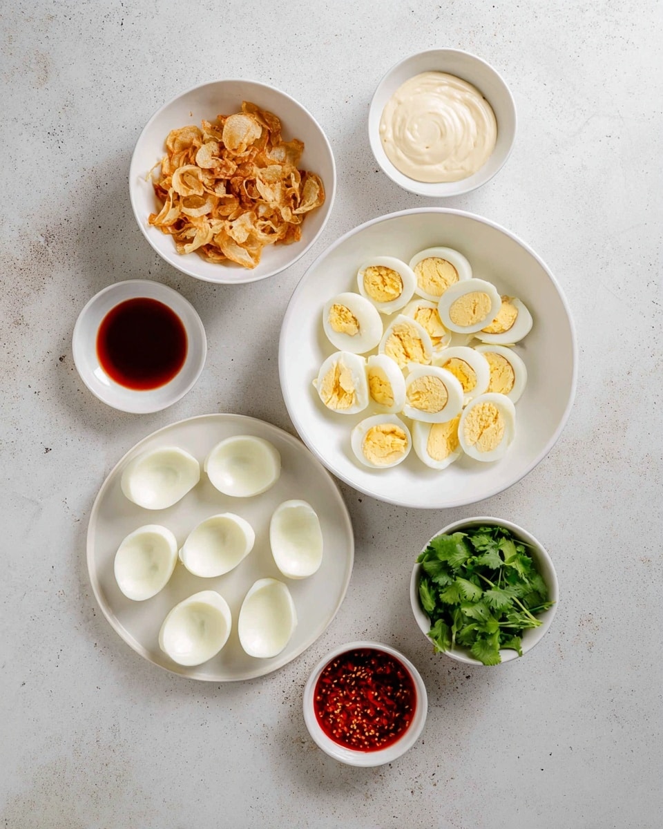 The image shows a flat lay of five white bowls and a white plate arranged on a white marbled surface. In the center, a large white bowl holds about a dozen halved cooked egg yolks with a firm texture and light yellow color. Below this, a white plate displays eighteen empty white egg halves neatly placed in rows. To the upper left of the central bowl, there is a smaller white bowl filled with crispy golden brown fried onions. To the upper right, a similar sized white bowl contains a smooth off-white mayonnaise-like sauce. Below the onions, a small white bowl holds a vibrant red chili oil. Finally, to the right of the chili oil, another small white bowl has fresh green cilantro leaves. The setup is clean and organized with a light, neutral background photo taken with an iphone --ar 4:5 --v 7