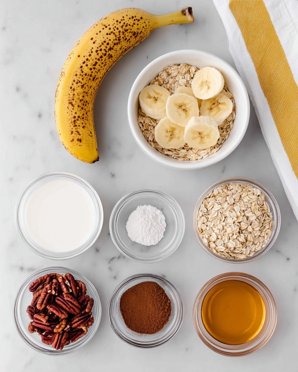 A white marbled surface holds an arrangement of ingredients for a recipe. At the top left is a ripe banana with brown spots. To its right are two white bowls; one filled with yellow banana slices and the other with beige rolled oats. Below these are five small transparent bowls lined up in two rows. The top row includes a bowl of white milk and a bowl of white powder. The bottom row has a bowl of chopped reddish-brown pecans, a bowl of dark brown liquid, and a bowl of light brown cinnamon powder. At the bottom right is a bowl with golden honey. A white towel with yellow stripes is partially visible on the right edge. photo taken with an iphone --ar 4:5 --v 7