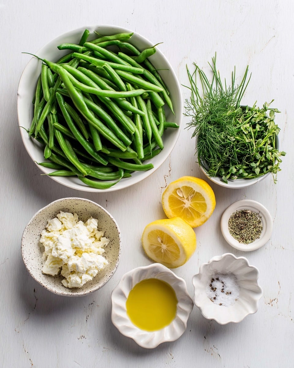 The image shows fresh ingredients arranged neatly on a white marbled surface. On the left, there is a white bowl filled with bright green, whole green beans. To the right, a small white bowl holds a mix of fresh green herbs, including dill and chives. Below it, there is a small speckled bowl filled with crumbly white cheese. Two lemon halves, showing their yellow juicy interiors, sit next to the cheese. Below the lemon, a small white bowl contains golden olive oil, and to the right, a small white fluted dish holds salt and black pepper. The setup is clean and simple with fresh colors highlighting the natural look of each ingredient. photo taken with an iphone --ar 4:5 --v 7
