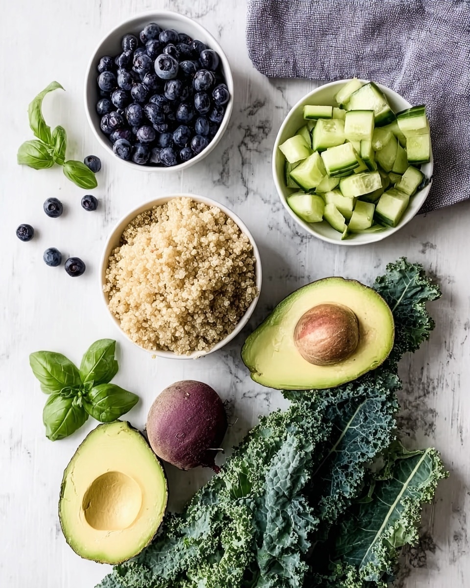The image shows an arrangement of fresh ingredients on a white marbled surface. There are three white bowls, one filled with small, dark blueberries, another with cooked quinoa that is light beige and fluffy, and the third with small, pale green cucumber chunks. Next to the bowls, there are two halves of a ripe avocado showing its bright green inside and a large brown pit in one half. There is also a medium-sized round beet with a reddish-brown skin. Large, bumpy kale leaves in dark green lie next to the bowls. Small sprigs of fresh basil with bright green leaves are scattered around. A folded gray cloth is placed near the top right corner. Photo taken with an iphone --ar 4:5 --v 7