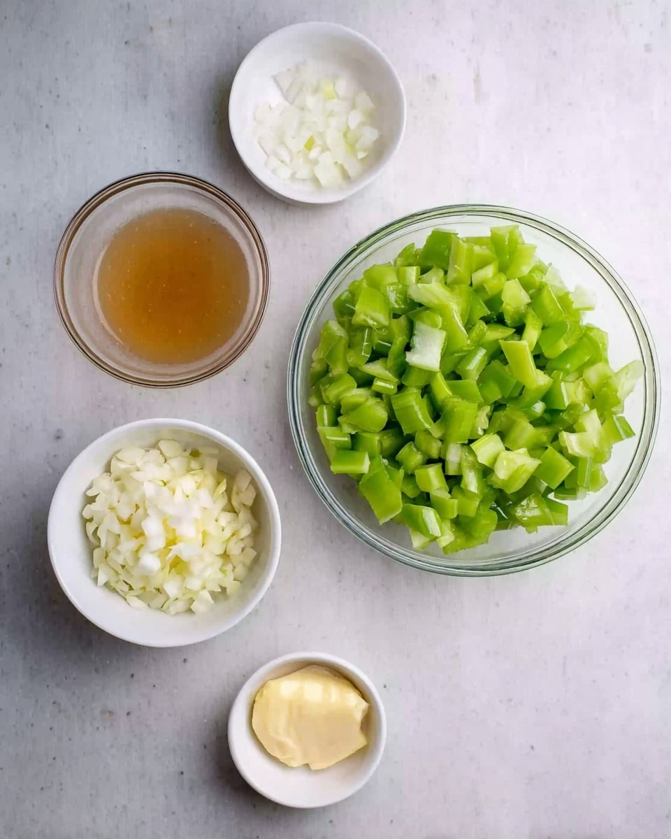 A clear glass bowl filled with bright green chopped celery pieces sits at the top right on a white marbled surface. Below it, a small clear glass bowl contains a light brown liquid. To the right of this, a small white bowl holds white chopped onion pieces. Next to that, a tiny white bowl has minced light yellow ginger inside. At the bottom right, another tiny white bowl has a small dollop of pale yellow butter. The whole scene is clean and simple, with ingredients arranged neatly. photo taken with an iphone --ar 4:5 --v 7